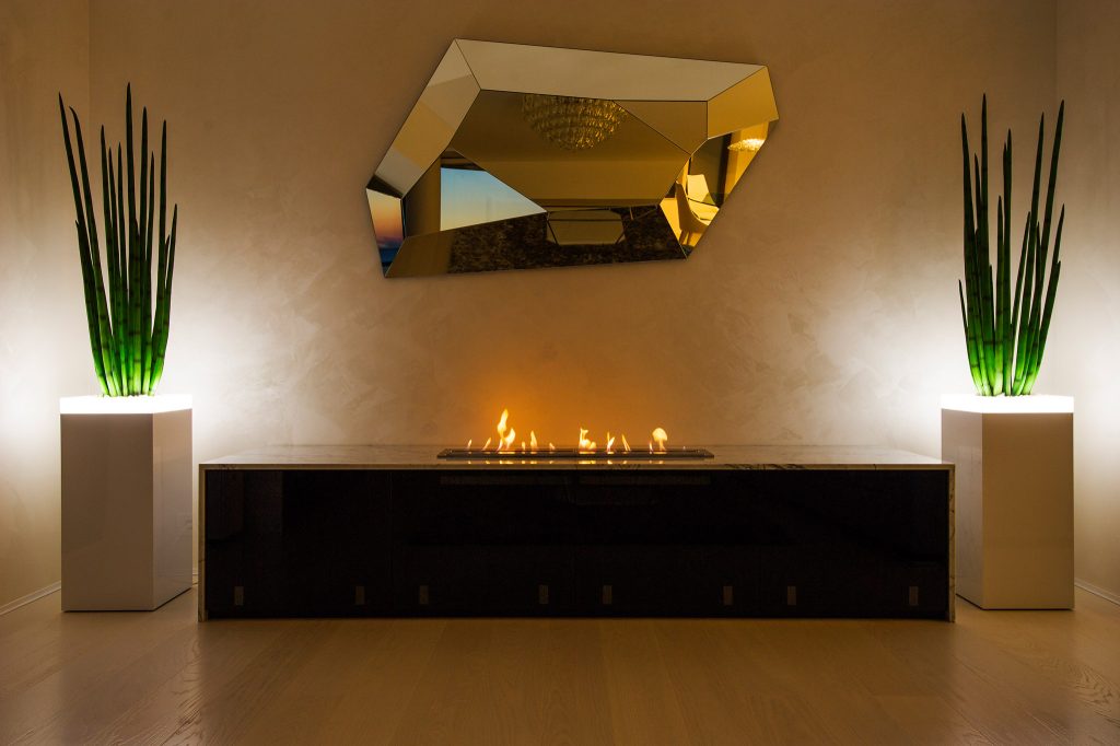 Burner V bioethanol fireplace embedded in furniture, showcasing modern design and integration in interior decor.