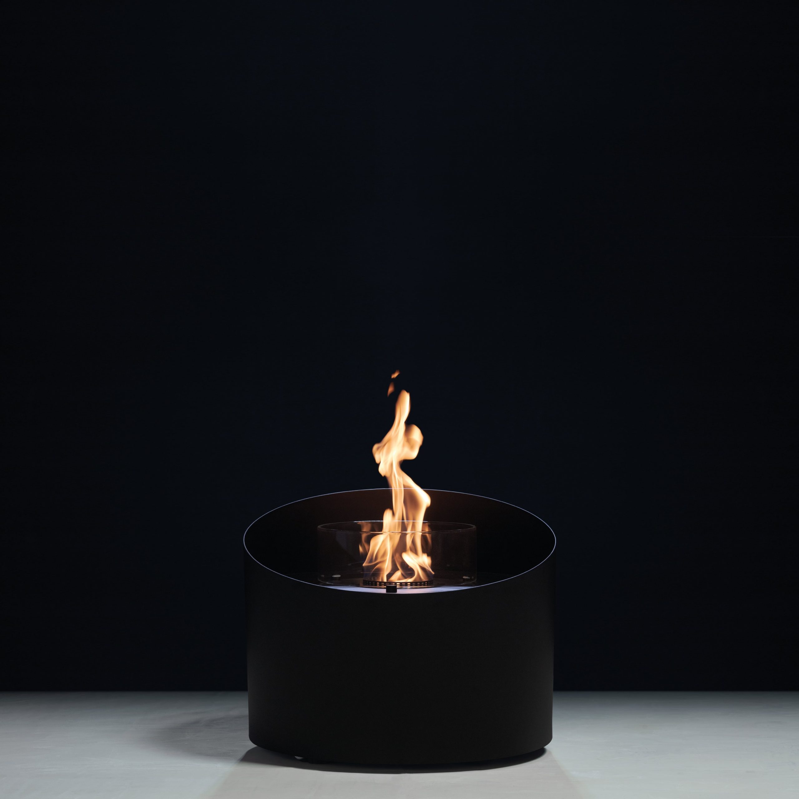 Contour bioethanol floor fireplace by GlammFire with minimalist black cylindrical design