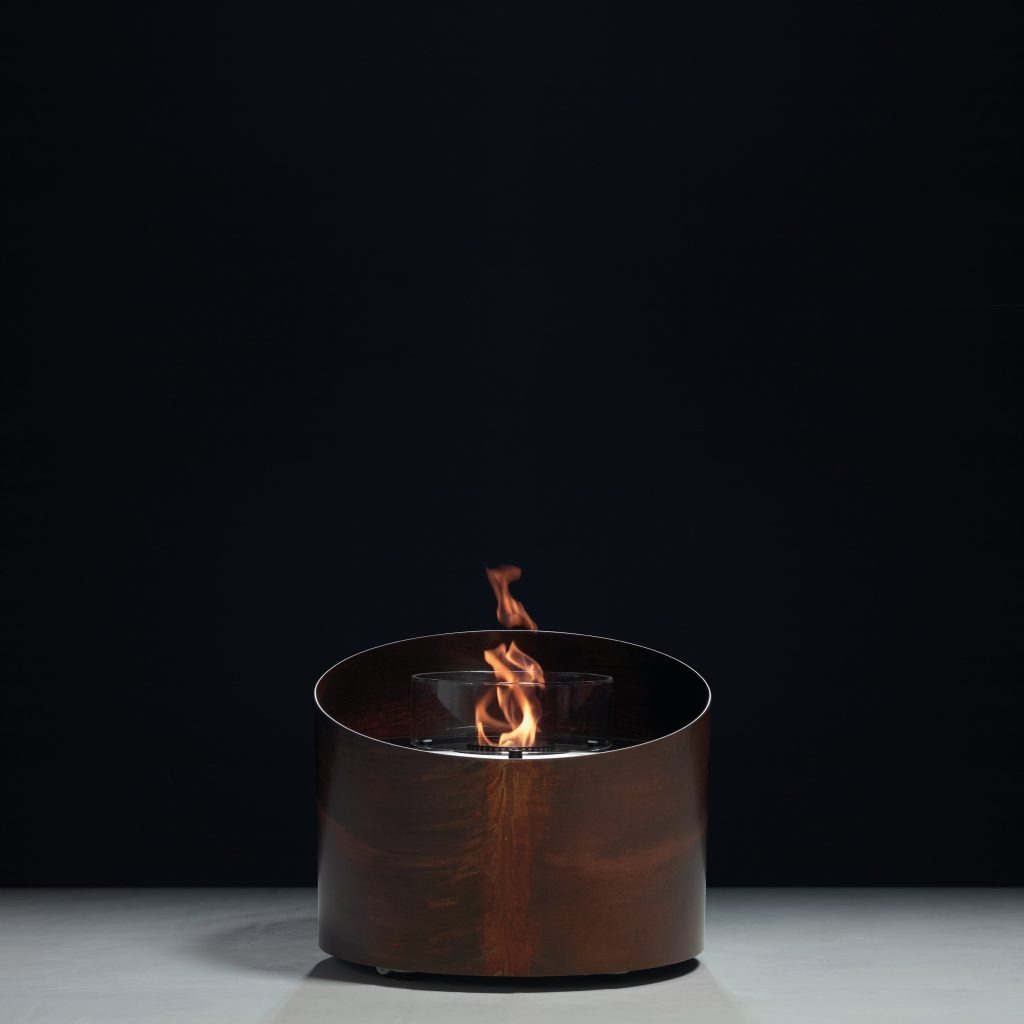 Contour bioethanol floor fireplace by GlammFire with corten steel finish and minimalist cylindrical design