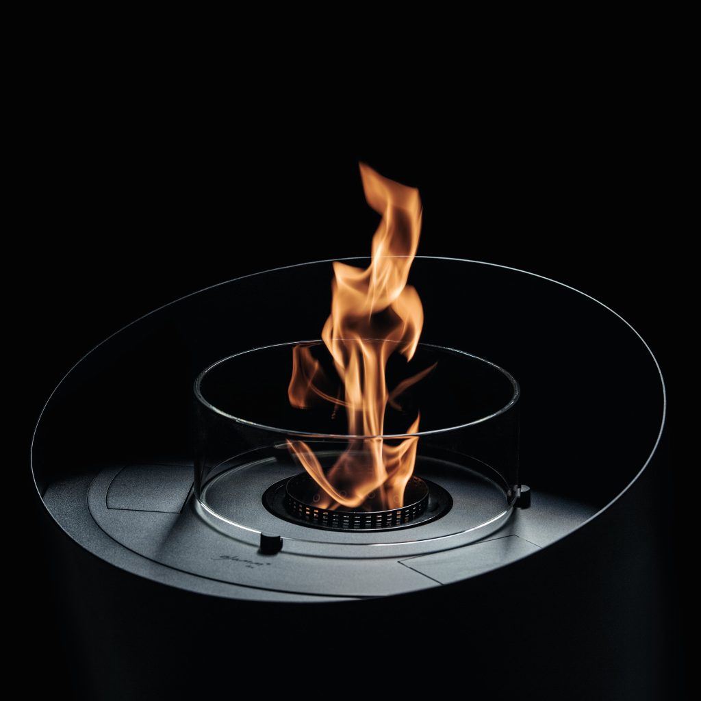 Close-up of Contour bioethanol floor fireplace by GlammFire, featuring a minimalist design with a visible flame