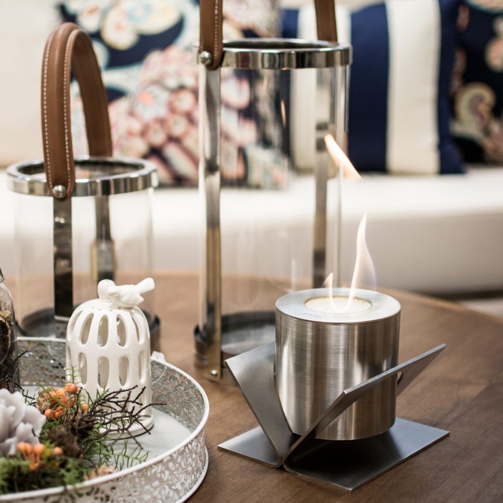 Kivo tabletop bioethanol fireplace by GlammFire elegantly displayed on a modern coffee table