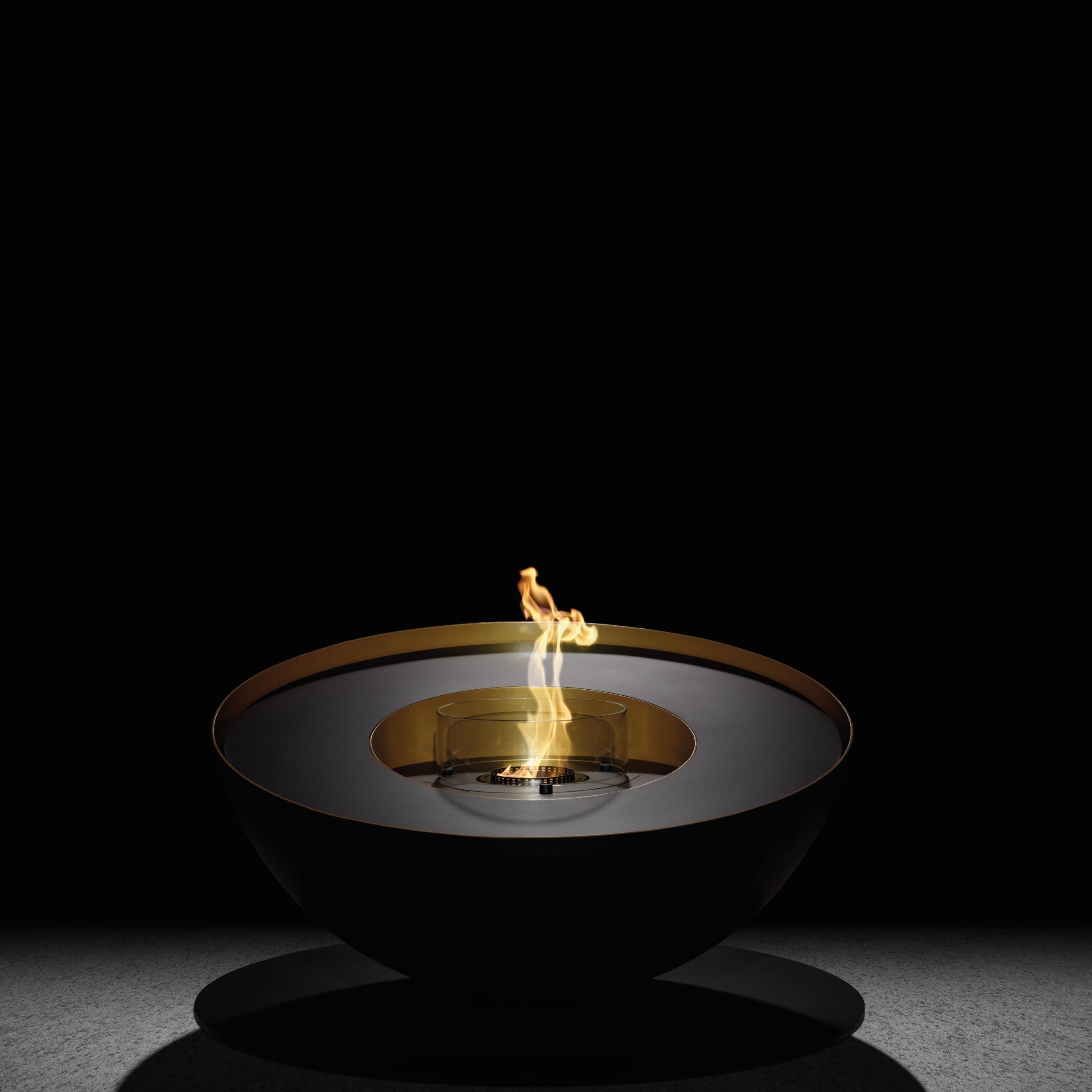 Mileto bioethanol floor fireplace by GlammFire, front view showing its modern, sleek design with a black and gold finish.