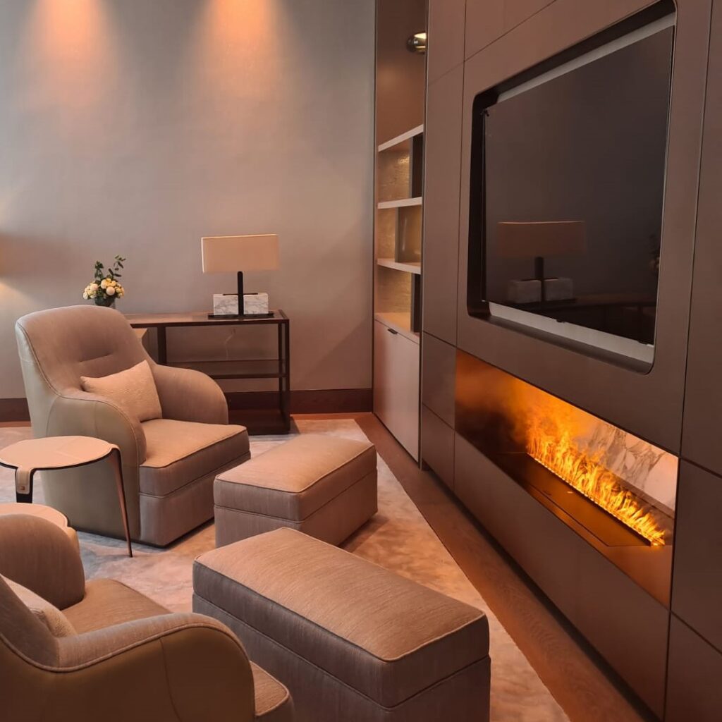 GlammFire Kit Glamm 3D Plus 1000 electric fireplace integrated in a luxury living room at Kastel showroom in Dubai, featuring warm lighting and neutral tones