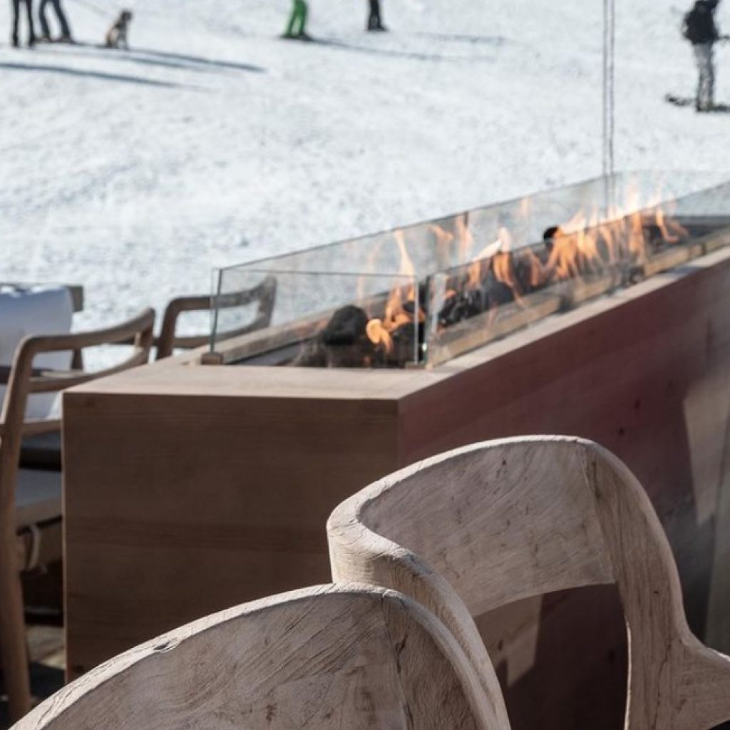 Rectangular gas combustion zone in an outdoor space by GlammFire, providing warmth in a stylish winter setting.