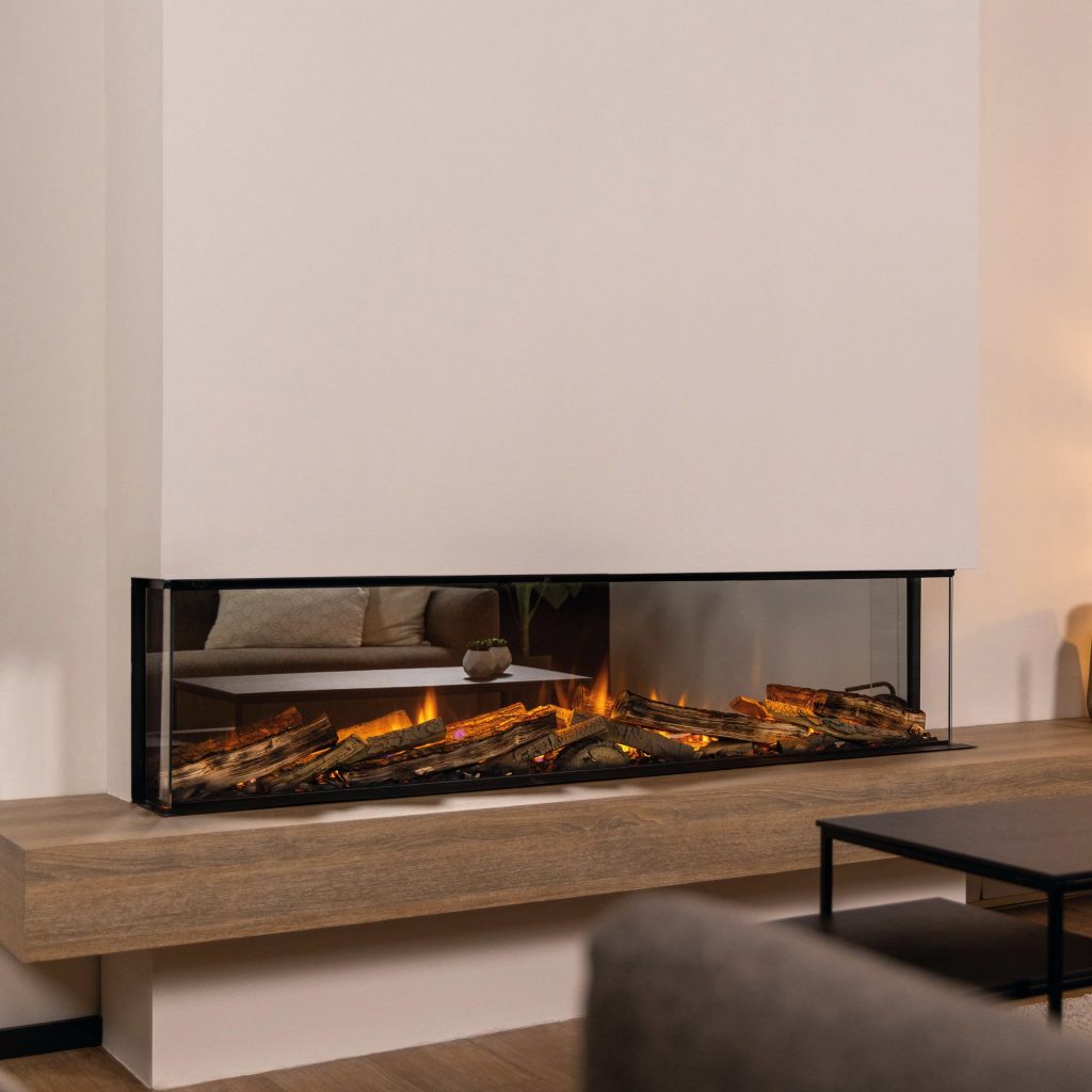 Full view of the Spectrum electric fireplace by GlammFire, showcasing realistic flames and glowing logs in a glass-enclosed design, mounted in a modern living room.
