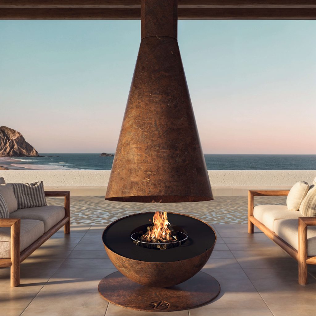 Thales Firewood suspended corten steel fireplace in an outdoor seating area with a stunning sea view.