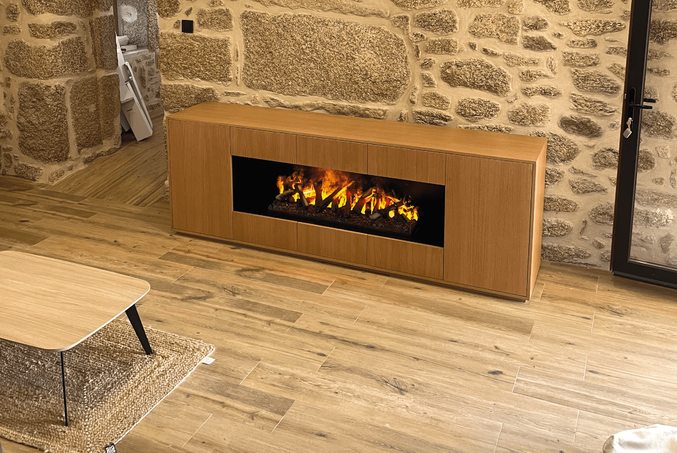 Kit-Optiv electric fireplace by GlammFire in a rustic living room with stone walls