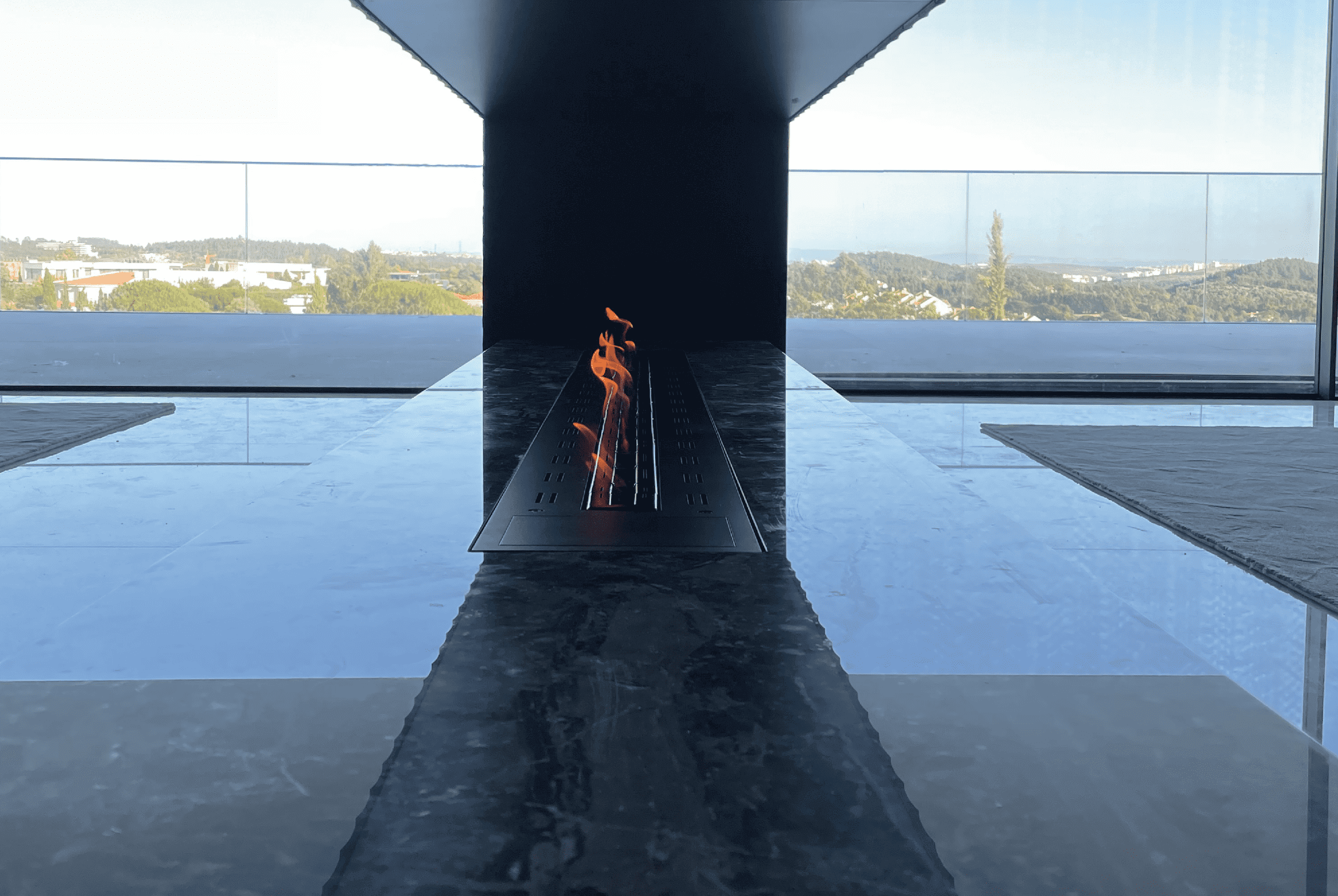 Fire Line bioethanol burner by GlammFire dividing two rooms with a modern panoramic view.