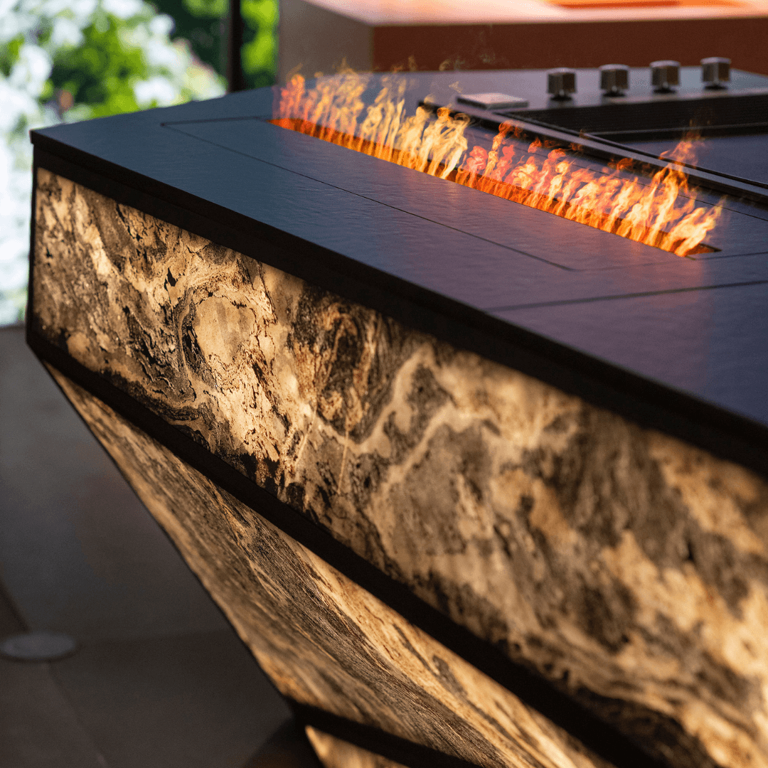 Concept outdoor kitchen by GlammFire with integrated fire feature and illuminated mineral surface