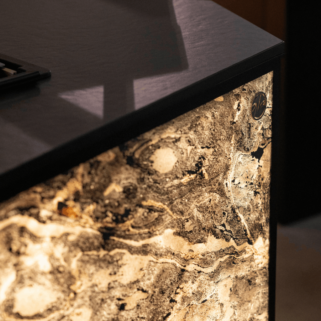 Concept outdoor kitchen illuminated side panel with GlammFire logo and Dekton worktop