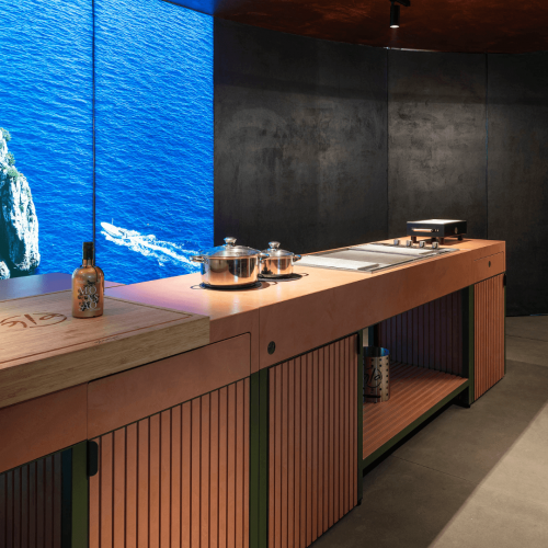 Side detail of Brezza outdoor kitchen showing worktop, cabinets and integrated appliances by GlammFire