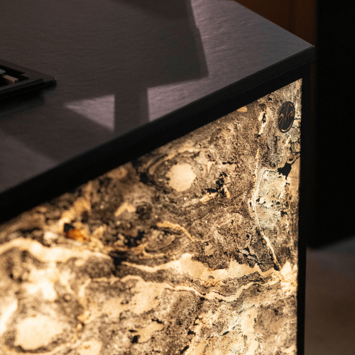 Concept outdoor kitchen illuminated side panel with GlammFire logo and Dekton worktop