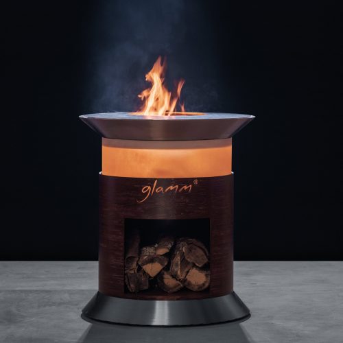 Close-up of Alba Grill by GlammFire, featuring a circular design with a fire pit and wood storage, perfect for outdoor cooking and entertaining.