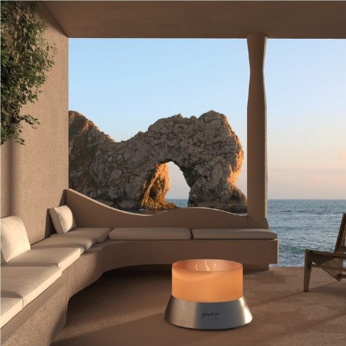 Alba gas fire pit on a coastal terrace with a stunning rock arch formation in the background.