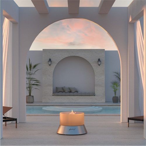 Alba gas fire pit in a luxurious outdoor patio with an arched structure and serene pool.