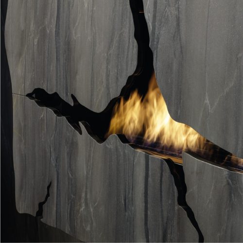 Close-up of the bespoke Apollo IV bioethanol wall fireplace, showcasing the custom cracks design by GlammFire.