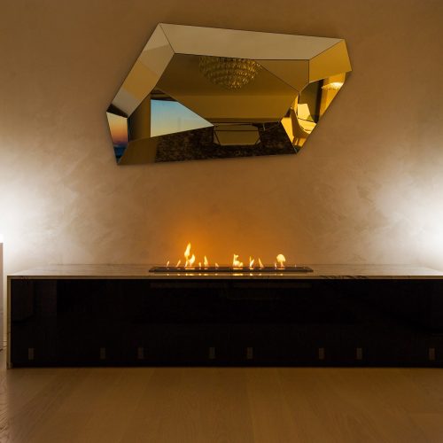Burner V bioethanol fireplace embedded in furniture, showcasing modern design and integration in interior decor.