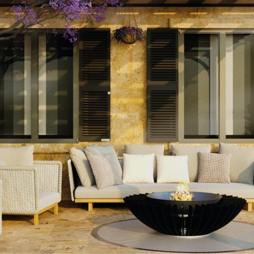 Cosmo 13 fire pit by GlammFire, wood-burning version, in a modern outdoor seating area with a contemporary black steel design.