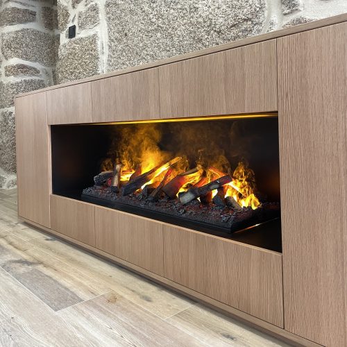 GlammFire Kit Glamm 3D Plus 1000 built-in electric fireplace with realistic flame effect, integrated in a natural wood cabinet against a stone wall