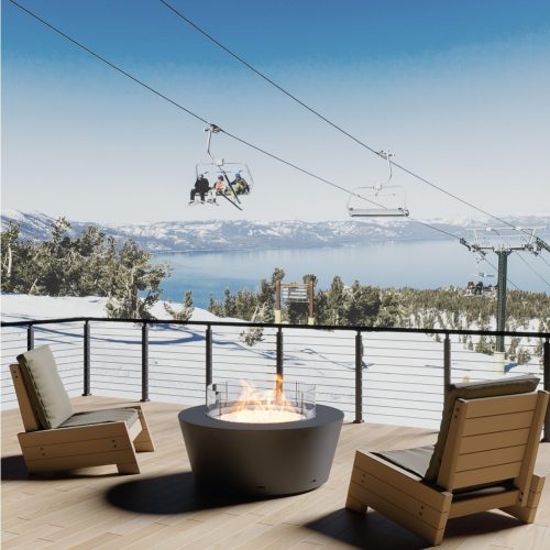 Otello gas fire pit on a snowy mountain resort terrace with ski lift view.