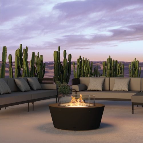 Otello gas fire pit with a sleek modern design in an outdoor desert setting.