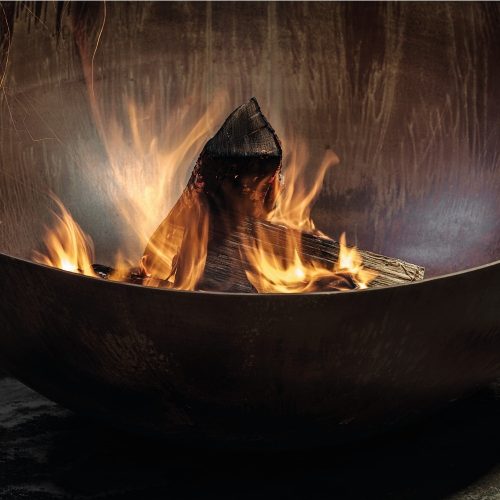 Close-up view of the Fire Pit Solace with wood burning flames.
