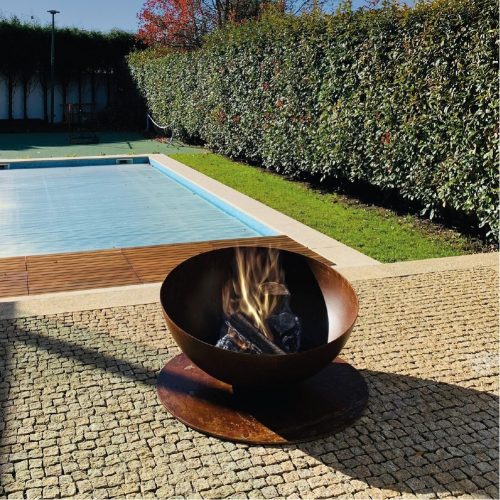 Fire Pit Solace near a pool in an outdoor garden.