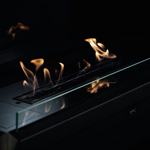 Close-up of the York bioethanol fireplace flames with a sleek glass enclosure by GlammFire.
