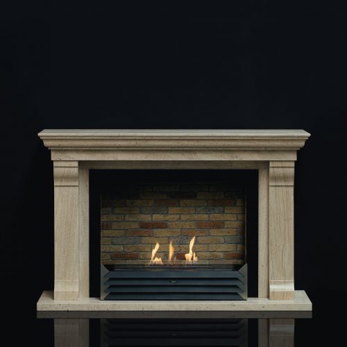 York bioethanol fireplace insert with a brick-lined background, encased in a classic stone mantel by GlammFire.