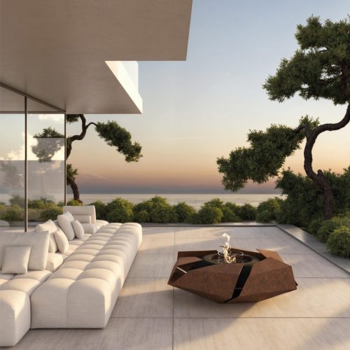 Image of the Stravaganza fire pit with a rusted corten steel finish on a modern, luxurious terrace. A comfortable sofa sits nearby, surrounded by lush greenery, with an incredible view of the sea and sunset. This unique fire pit adds a rustic yet elegant touch to the outdoor space, creating a perfect setting for relaxation.
